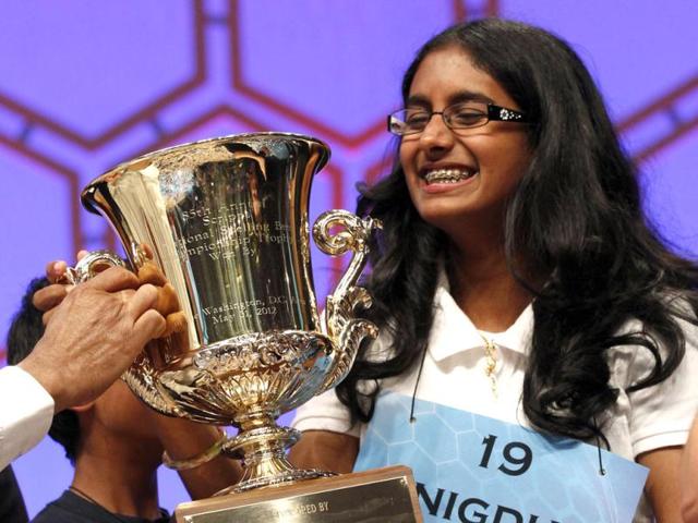 Snigdha Nandipati, 14, of San Diego, California, holds her trophy after winning the Scripps National Spelling Bee at National Harbor in Maryland. Reuters/Kevin Lamarque