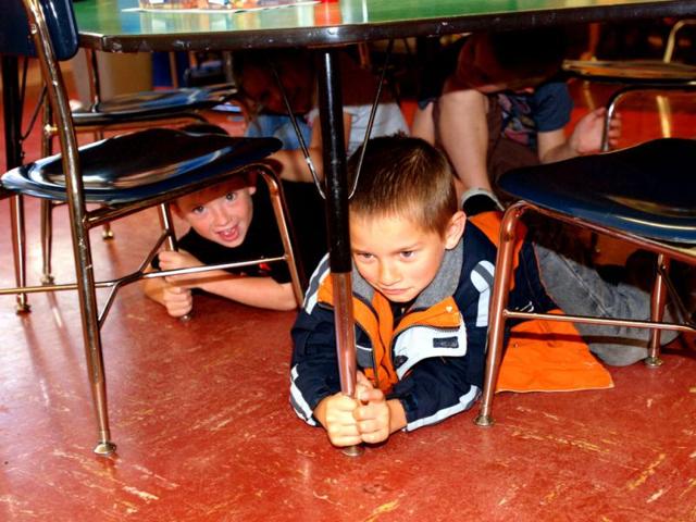 Kindergarteners duck and cover during an earthquake and tsunami drill at Blossom Gulch Elementary School in Coos Bay, Ore. AP/Jeff Barnard