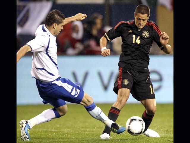 Mexico forward Javier Hernandez (14) controls the ball against Bosnia-Herzegovina defender Sanel Jahic during the second half of an international friendly soccer match in Chicago. Mexico won 2-1. AP/Nam Y Huh