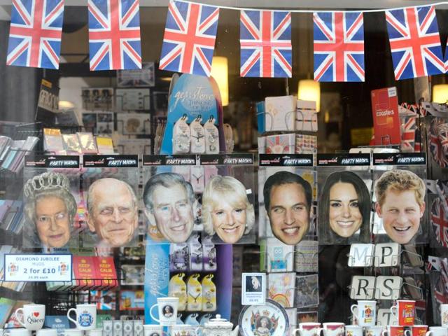 Souvenirs including paper masks of (L-R) Britain's Queen Elizabeth II, Prince Philip, Duke of Edinburgh, Prince Charles, Prince of Wales, Camilla, Duchess of Cornwall, Prince William, Catherine, Duchess of Cambridge and Prince Harry are displayed at a store in central London ahead of the long weekend of celebrations to mark the Queen's diamond jubilee. AFP/Leon Neal