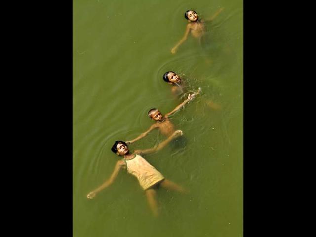 Young boys submerge themselves in water to cool off on a hot summer day in Jaunpur. The weather in northern India has been extremely hot in recent days with temperatures reaching as high as 45 degrees Celsius. (AP Photo)