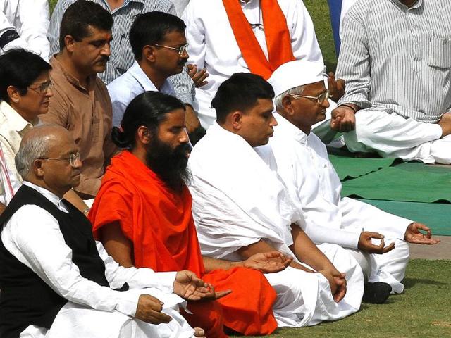 Anti-corruption crusader Anna Hazare (C) with yoga guru Baba Ramdev, Acharya Balkrishana and other supporters, offers tributes at the Mahatma Gandhi memorial, before starting their day long fast in New Delhi. HT/Arvind Yadav