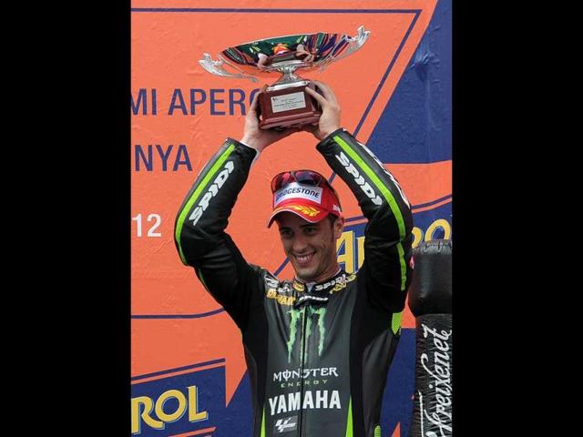Monster Yamaha Tech 3's Italian Andrea Dovizioso celebrates on the podium after the MotoGP race of the Catalunya Moto GP at the Catalunya racetrack in Montmelo, near Barcelona. AFP/Lluis Gene