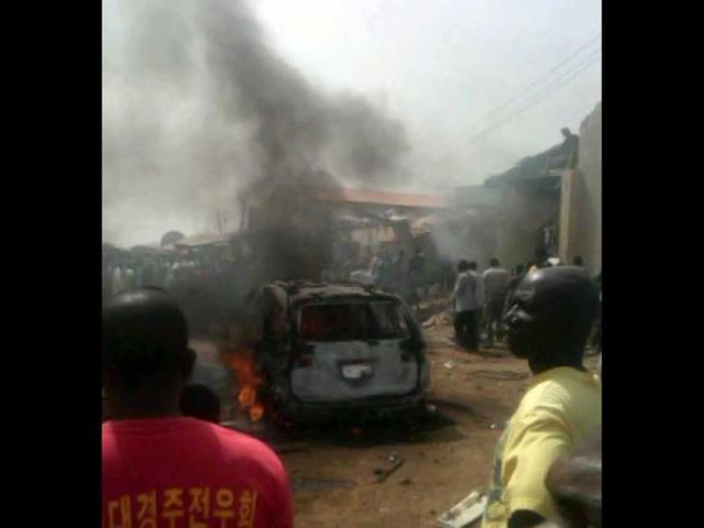 Iju district of Lagos gathering at the site where a Dana company aircraft crashed into a two-storey building on June 3, 2012 in Lagos. More than 150 passengers are feared dead, an aviation official and residents said. Thick smoke rose from the area near the Lagos airport and flames could be seen coming from the building. Residents said the plane had been coming in low, making a loud noise, when it slammed into the residential area. AFP PHOTO / CKN