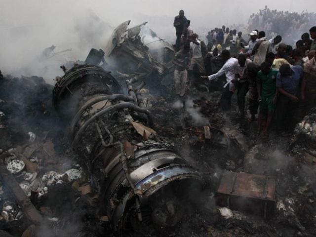 People gather at the site of a plane crash in Lagos, Nigeria. AP/Sunday Alamba