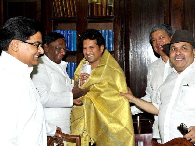 Sachin Tendulkar being honoured with a shawl by members of Parliament during the swearing-in ceremony at Parliament House in New Delhi.