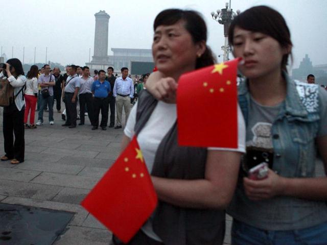 Tourists gather for the flag raising ceremony on Tiananmen Square to mark the anniversary of the deadly 1989 crackdown on pro-democracy protestors, in Beijing. AP/Ng Han Guan