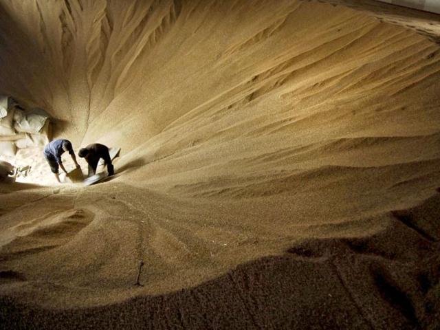 Workers pack wheat at a foodstuff storage site in Xiangfan, in central China's Hubei province. Reuters/Stringer, File