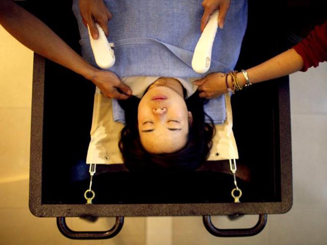 Students practice with a volunteer during an undertaker service class at the Tianquanjiajing Funeral Service school in Jiaxing, Zhejiang province. A new breed of young Chinese undertakers are fighting centuries-old taboos to gain social acceptance for their profession, saying they help the deceased and their families make their final parting with respect.(Reuters)