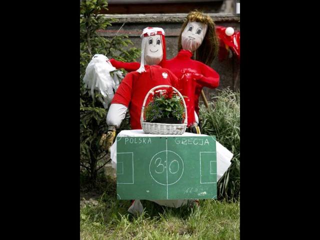 Puppets made by residents, dressed in Poland's national soccer team colours stand behind a prediction for the result of Poland's opening Euro 2012 soccer match against Greece, in Opalenica. Reuters/Bartosz Jankowski