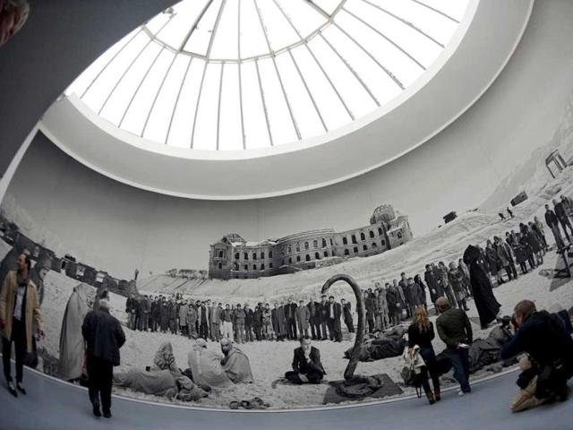 Visitors look at the work titled "Of what is, that it is; of what is not, that is not 1, 2012", a tapestry commissioned and produced by Documenta (13) and made by Polish-born artis Goshka Macuga, during a preview of the Documenta (13) fair for contemporary art in Kassel, central Germany. AFP/Barbara Sax