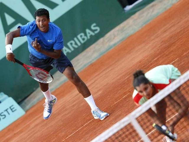 Mahesh Bhupathi (L) serves near Sania Mirza as they play against Poland's Klaudia Jans-Ignacik and Mexico's Santiago Gonzalez during their mixed doubles final match of the French Open tennis tournament at the Roland Garros stadium in Paris. AFP/Kenzo Tribouillard