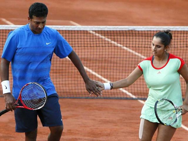 Sania Mirza and Mahesh Bhupathi (L) celebrate after a point as they play against Poland's Klaudia Jans-Ignacik and Mexico's Santiago Gonzalez during their mixed doubles final of the French Open tennis tournament at the Roland Garros stadium in Paris. AFP/Kenzo Tribouillard