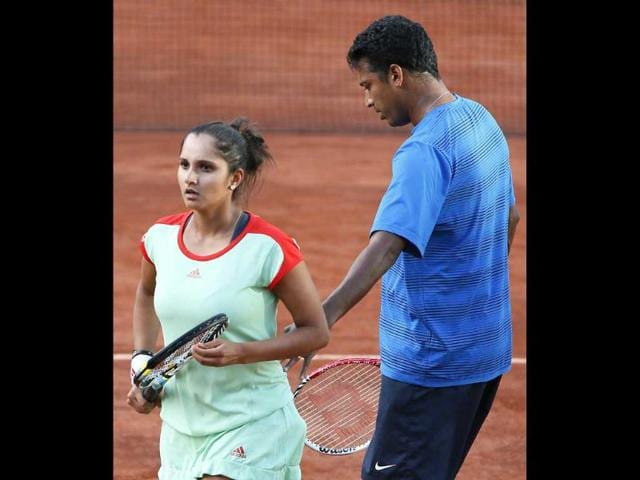 Sania Mirza and Mahesh Bhupathi (R) react after a point as they play against Poland's Klaudia Jans-Ignacik and Mexico's Santiago Gonzalez at the Roland Garros stadium in Paris. AFP/Kenzo Tribouillard