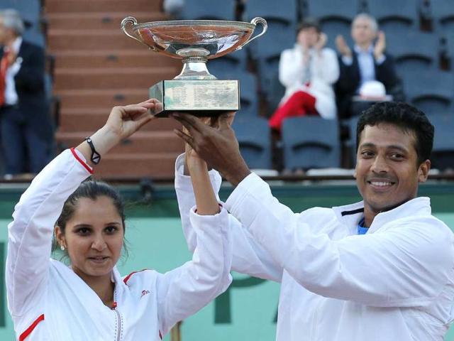 Sania Mirza, left, and Mahesh Bhupathi hold their cup after defeating Poland's Klaudia Jans-Ignacik and Mexico's Santiago Gonzalez in their mixed doubles final match of the French Open tennis tournament at the Roland Garros stadium in Paris. The Indian pair won 7-6, 6-1. AP/Michel Euler