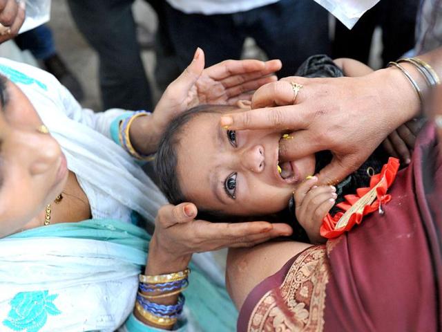 A member of the Bathini Goud family administers fish medicine to a patient at the Katedan stadium in Hyderabad. The medicine is administered on the auspicious day of Mrigasira Karti which falls in June with the onset of the annual monsoon. AFP Photo/Noah Seelam
