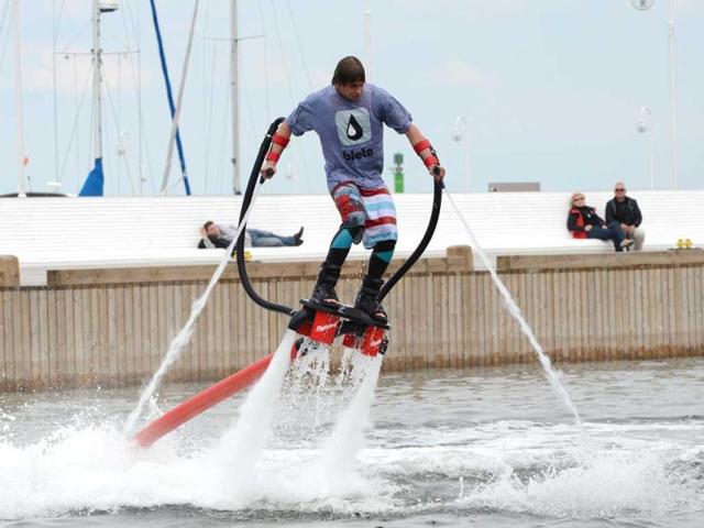 A man with hydro shoes flies over the water at a beach on the Baltic Sea in Sopot. AFP/Patrik Stollarz