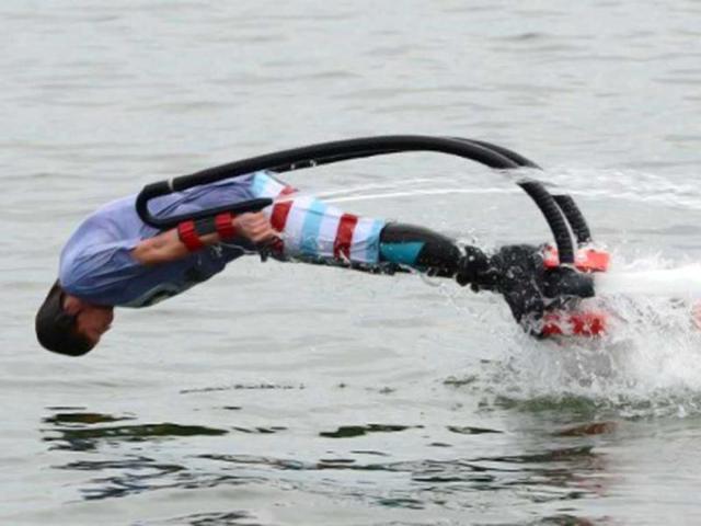 A man with hydro shoes flies over the water at a beach on the Baltic Sea in Sopot. AFP/Patrik Stollarz