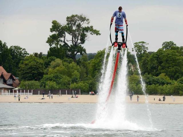 A man with hydro shoes flies over the water at a beach on the Baltic Sea in Sopot. AFP/Patrik Stollarz