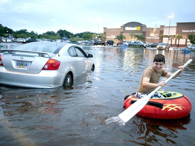 A resident makes his way through a parking lot in the Warrington area of Pensacola Florida. A storm moving across the US Gulf Coast battered parts of Alabama and Florida with up to 18 inches of rain on Saturday with authorities declaring a state of emergency. (Reuters)
