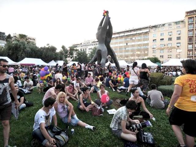 Participants of the Athens gay pride event listen to live music at an central Athens square, following a parade. Some 1000 people took part at a march organised by Greece's gay and lesbian community, with the main slogan ' love me, its for free' . AFP Photo/ Louisa Gouliamaki