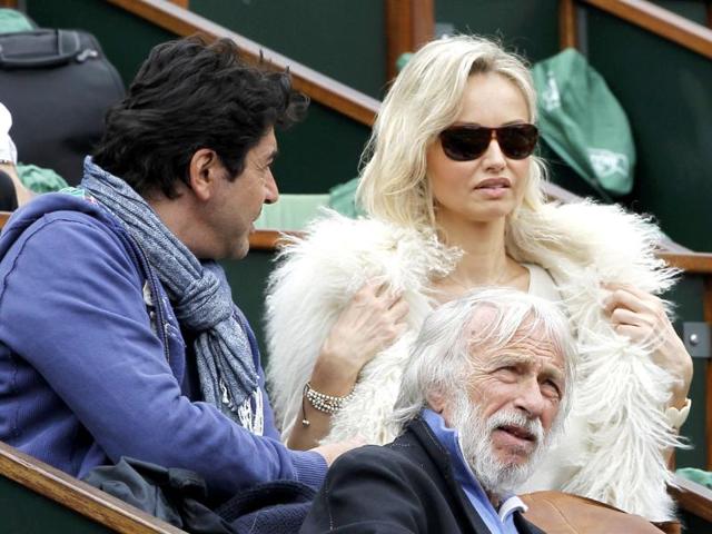 Model Adriana Karembeu (R) and actor Pierre Richard (C) attend the men's singles final match between Rafael Nadal of Spain and Novak Djokovic of Serbia during the French Open tennis tournament at the Roland Garros stadium in Paris Reuters/Gonzalo Fuentes