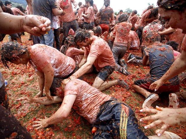 Revellers play with tomato pulp during the annual "Tomatina" (tomato fight) in Sutamarchan Province in Boyaca. (Reuters/John Vizcaino)