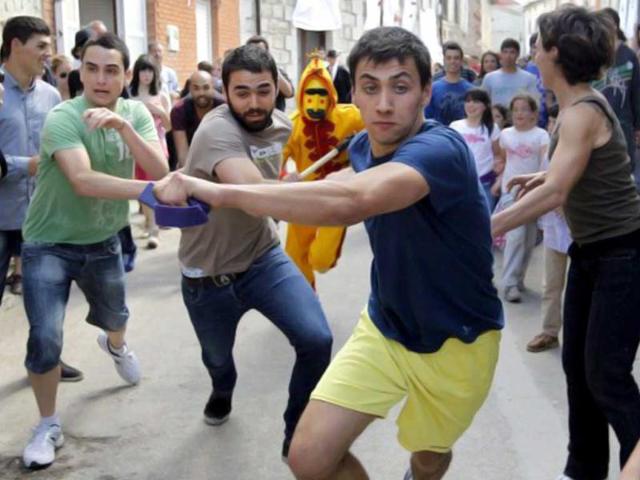 A man dressed up as the devil (C) young men during 'El Colacho', the 'baby jumping festival' in the village of Castrillo de Murcia, near Burgos. Baby jumping (El Colacho) is a traditional Spanish practice dating back to 1620 that takes place annually to celebrate the Catholic feast of Corpus Christi. During the act - known as El Salto del Colacho (the devil's jump) or simply El Colacho - men dressed as the Devil jump over babies born the last twelve months of the year who lie on mattresses in the street. AFP Photo / Cesar Manso
