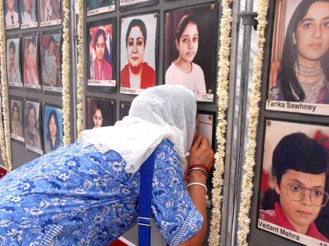 Relatives of Uphaar tragedy victims paying tribute to the departed souls, at the memorial set up near the cinema hall, in New Delhi, on the 15th anniversary of the tragedy.UNI