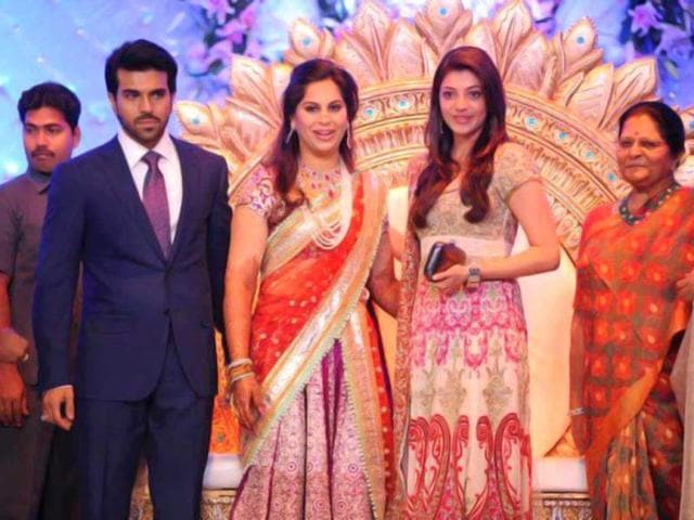 Bollywood actor Kajal poses with the couple.