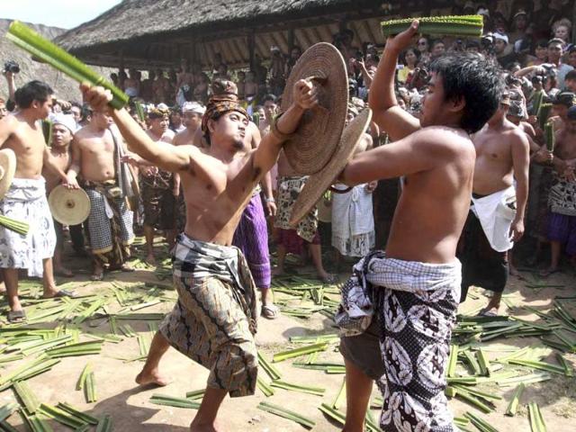 Balinese men fight while using tied thorny pandanous leaves as their weapon during Mekare Kare ritual in Teganan, Indonesia. Mekare Kare is the highlight of a local Hindu ceremony. AP/Firdia Lisnawati