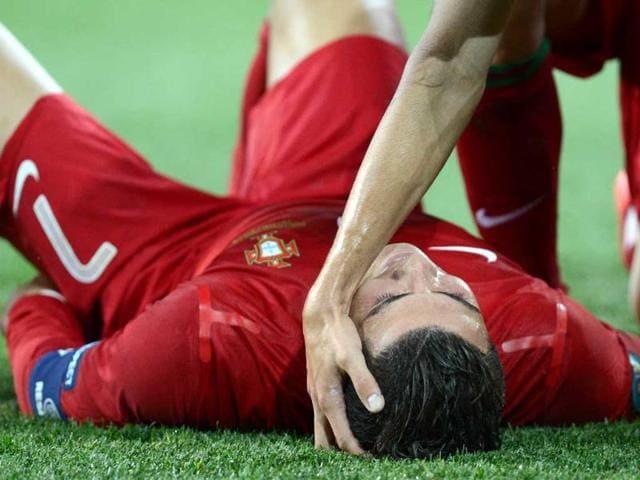 Portuguese forward Cristiano Ronaldo celebrates with teammates after scoring his second goal during the Euro 2012 football championships match Portugal vs. Netherlands at the Metalist stadium in Kharkiv. AFP/Patrick Hertzog