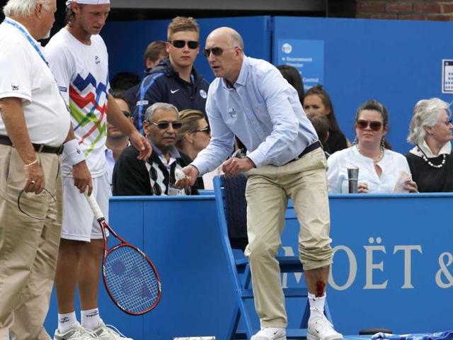 Line-judge-Andrew-McDougall-shows-his-injury-after-David-Nalbandian-kicked-a-hoarding-during-his-men-s-singles-final-match-at-the-Queen-s-Club-tennis-tournament-in-London-Reuters-Suzanne-Plunkett Line-judge-Andrew-McDougall-shows-his-injury-after-David-Nalbandian-kicked-a-hoarding-during-his-men-s-singles-final-match-at-the-Queen-s-Club-tennis-tournament-in-London-Reuters-Suzanne-Plunkett