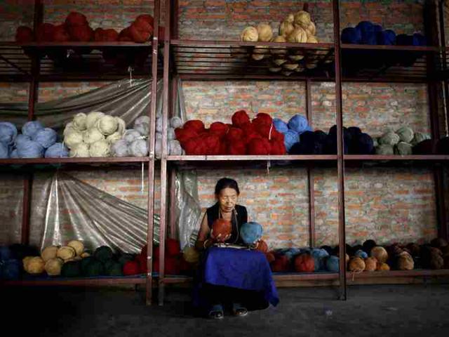Chime, 72, works in the Tibetan Handicraft Center, at a Tibetan refugee camp, in Kathmandu. AP/Niranjan Shrestha
