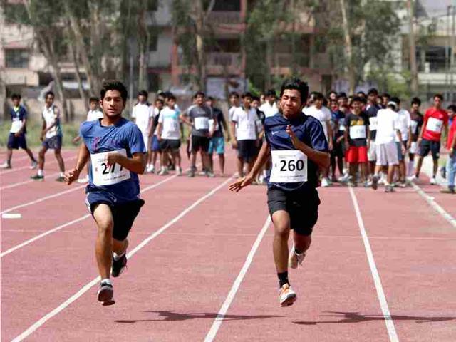 Aspirant students running a 50m dash during the Fitness trail test for admission at Shri Ram College of Commerce in New Delhi. HT/M Zhazo