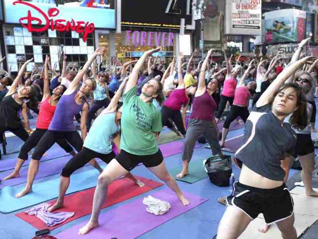 People practice yoga on the morning of the summer solstice in New York's Times Square. (Reuters/Shannon Stapleton)