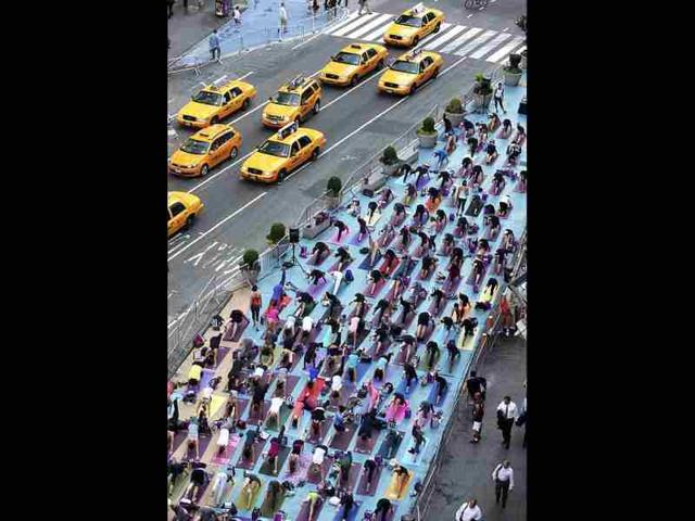 People practice yoga on the morning of the summer solstice in New York's Times Square. (Reuters/Shannon Stapleton)