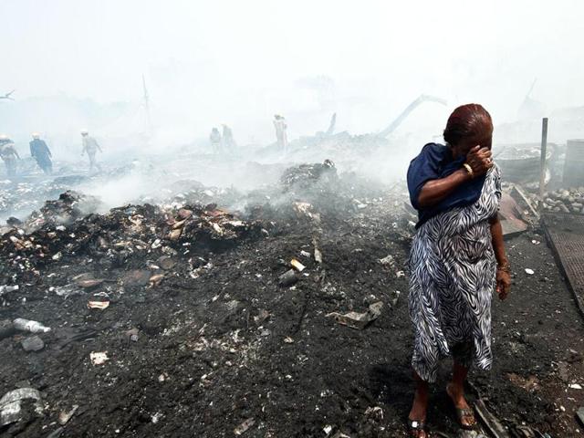 A resident breaks down after her shanty was gutted during a fire in New Delhi. Around 100 dwellings were gutted in a fire at a slum cluster and in an adjoining scrapyard. AFP Photo/Prakash Singh