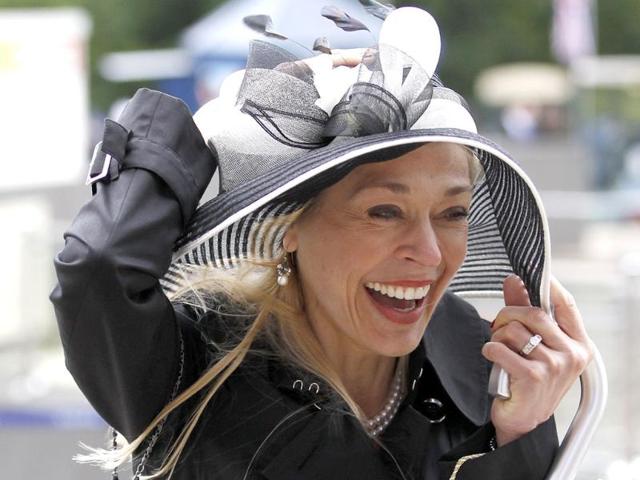 A race goer struggles to keep her hat on in strong winds on the fourth day at Royal Ascot, southwest of London. (Reuters/Andrew Winning)