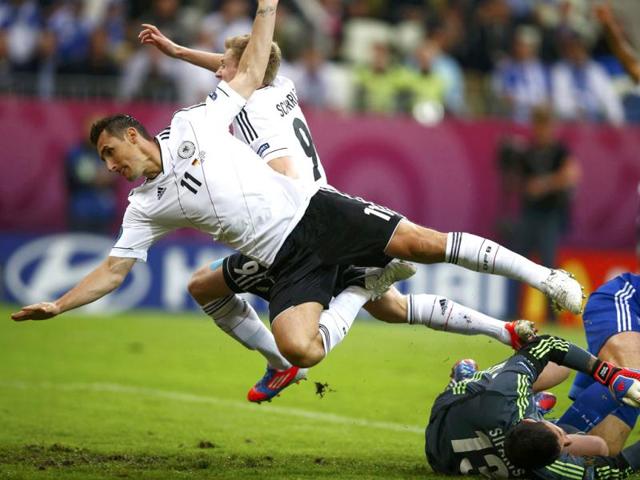 Germany's Miroslav Klose and Andre Schuerrle (rear) fall over Greece's goalkeeper Michalis Sifakis during their Euro 2012 quarter-final soccer match at the PGE Arena in Gdansk. (Reuters/Kai Pfaffenbach)