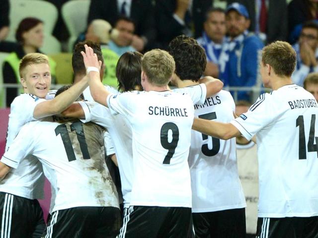German defender Philipp Lahm (hidden) celebrates with teammates after scoring during the Euro 2012 football championships quarter-final match Germany vs Greece at the Gdansk Arena.(AFP Photo/Ane-Christine Poujoulat)