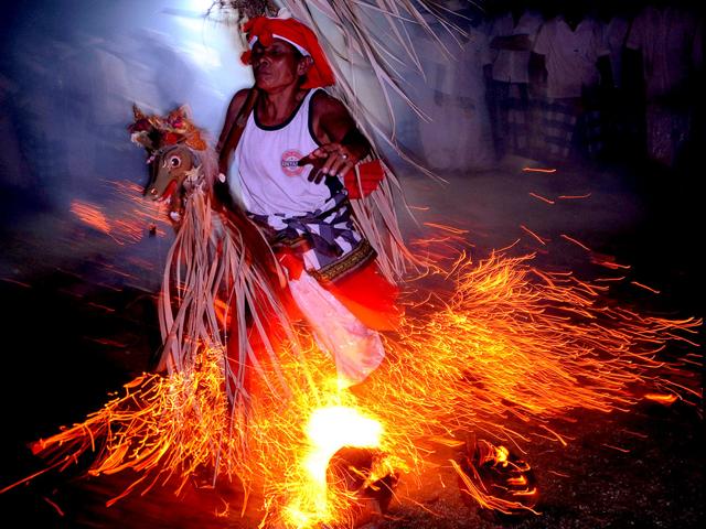 A Balinese man walking across a fire during the Sanghyang jaran ritual dance performed at a temple in Kuta, Indonesia's resort island of Bali. Sanghyang jaran is a dance performed by boys who ride coconut palm hobbyhorses in and around a fire. AFP/Sonny Tumbelaka