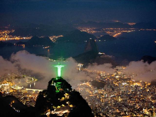 An aerial view of Christ the Redeemer statue is lit up in green in Rio de Janeiro. Reuters/Siemens