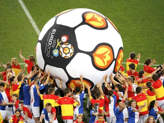 Performers push a giant soccer ball with the Euro 2012 logo before the quarter-final soccer match between Spain and France. Reuters/Yves Herman