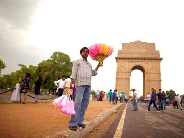 A vendor holds candies for sale in front of the India Gate against the backdrop of pre-monsoon clouds in New Delhi. The India Meteorological Department (IMD) has forecast average rainfall for the whole June to September. Reuters/Ahmad Masood