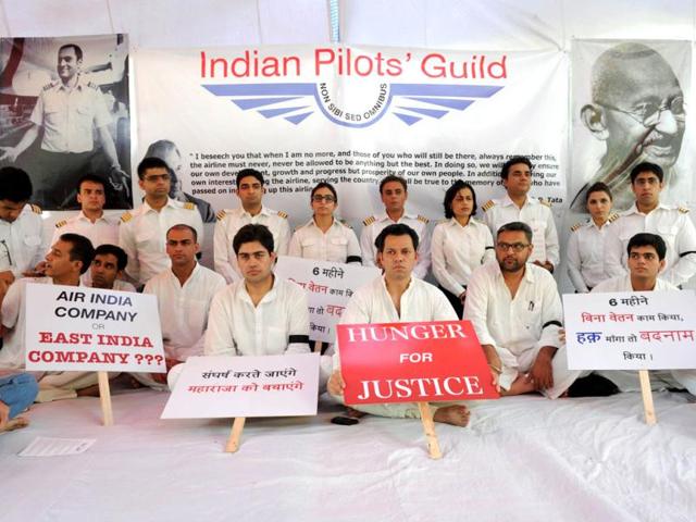 Striking Air India pilots hold placards during a hunger strike in New Delhi. Eleven pilots belonging to Indian Pilots' Guild (IPG) began an indefinite hunger strike demanding the reinstatement of their 101 sacked colleagues. AFP Photo/Sajjad Hussain