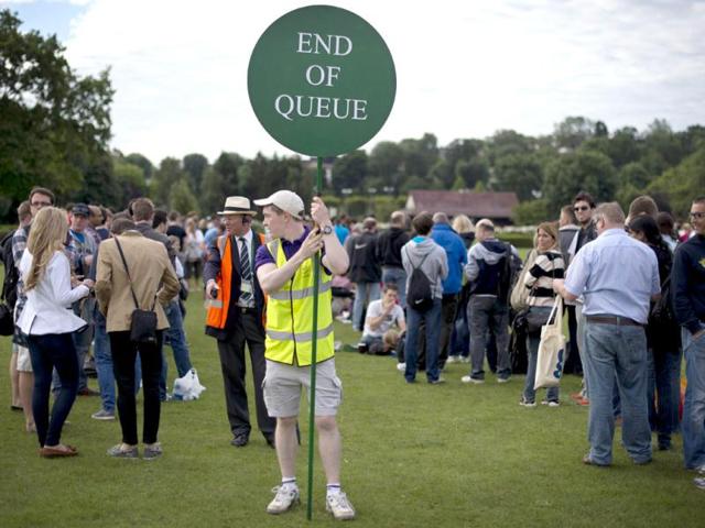 A steward holds a sign as tennis fans queue for tournament tickets to watch the action on the second day of the 2012 Wimbledon Championships tennis tournament at the All England Tennis Club in Wimbledon, southwest London. (AFP Photo) A steward holds a sign as tennis fans queue for tournament tickets to watch the action on the second day of the 2012 Wimbledon Championships tennis tournament at the All England Tennis Club in Wimbledon, southwest London. (AFP Photo)