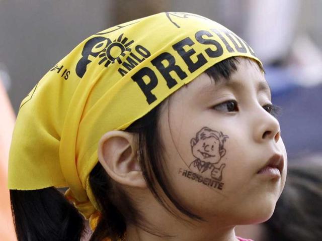 A child, with her face painted in support of leftist presidential candidate Andres Manuel Lopez Obrador, looks on during his last campaign rally in Mexico City. Lopez Obrador, a former mayor of Mexico City who narrowly lost the 2006 election to Felipe Calderon, is the closest rival to frontrunner Enrique Pena Nieto. Reuters/Henry Romero
