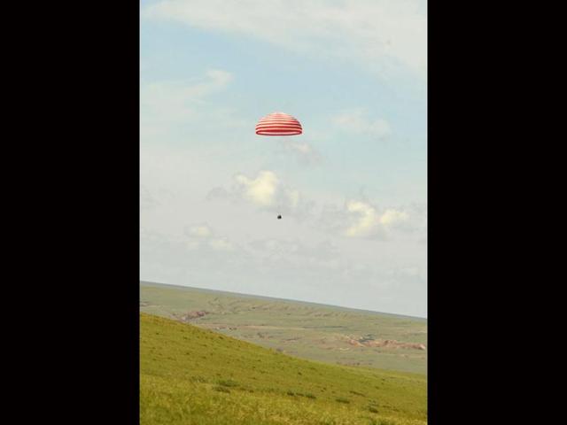 This photo released by China's Xinhua News Agency shows the re-entry capsule of China's Shenzhou 9 spacecraft touching down in Siziwang Banner of north China's Inner Mongolia Autonomous Region. AP Photo/Xinhua, Ren Junchuan
