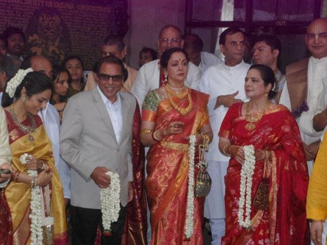 Parents of the bride Dharmendra and Hema Malini wait for the baraat.